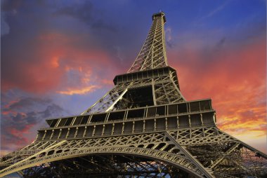 Eiffel Tower at Sunset against a Cloudy Sky clipart