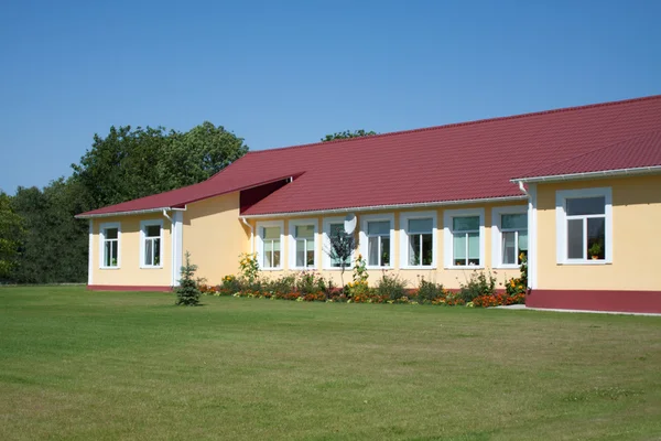 stock image Building of the new kindergarden on blue sky