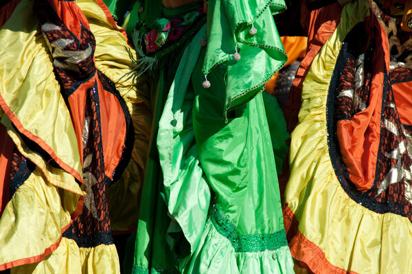 Close-up of colorful clothing, dancers in skirts