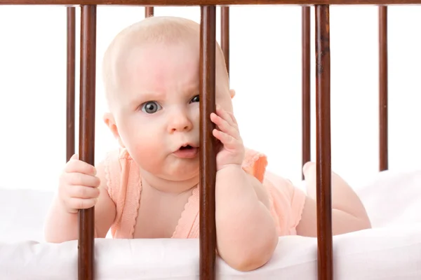 The kid in the crib on a white background. — Stock Photo, Image
