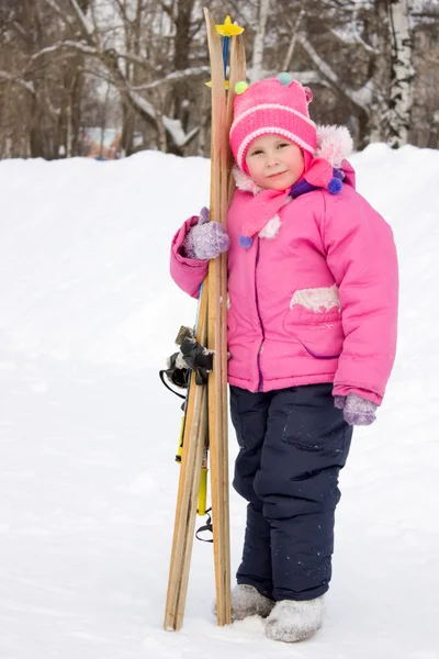 Meisje met ski's in de hand. — Stockfoto