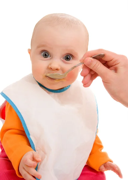 Dziecko zjada na białym tle. — Zdjęcie stockowe