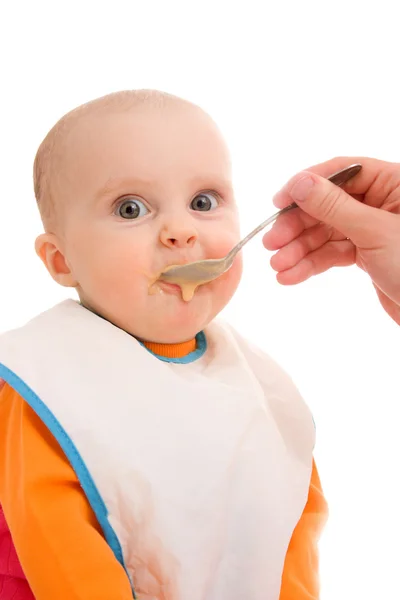 Kid eats on a white background. Stock Photo