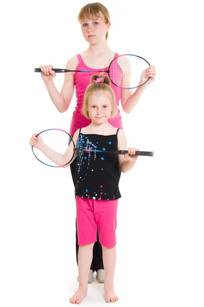 Lányok, egy teniszütő, egy fehér háttér. — Stock Fotó