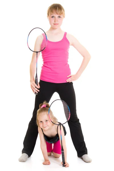 Meninas com uma raquetes em um fundo branco . — Fotografia de Stock