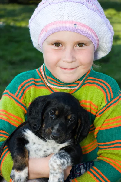 Het meisje met de puppy in haar armen. — Stockfoto