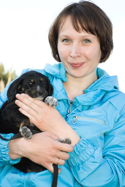 Žena s štěně v náručí. — Stock fotografie
