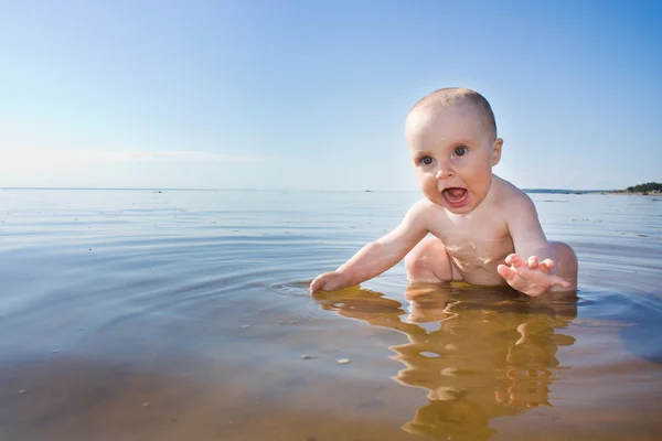 stock image Baby swims in the sea.