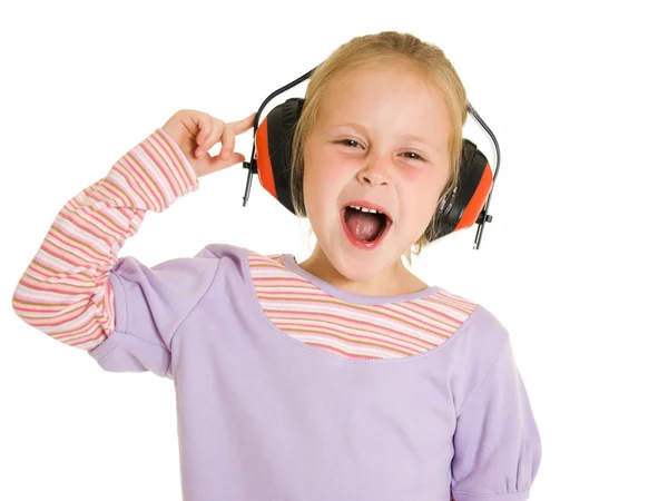 Little girl listening to music on white background — Stock Photo, Image