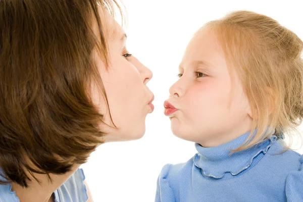 Mom and daughter kissing a white background. — Stock Photo, Image