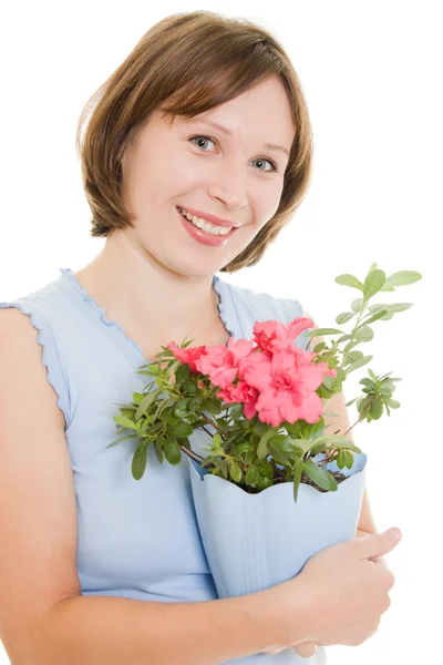 Dívka vonící květinu na bílém pozadí. — Stock fotografie