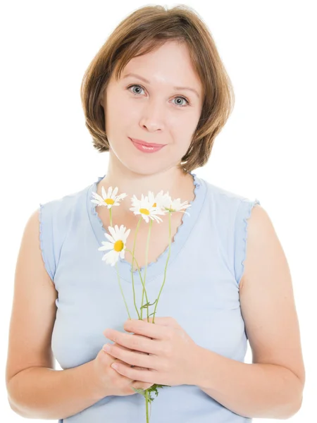 Menina cheirando uma flor em um fundo branco . — Fotografia de Stock