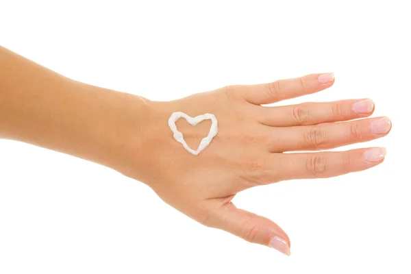 stock image Cream in a female hand on heart.