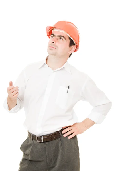 Businessman in a helmet looking up. — Stock Photo, Image