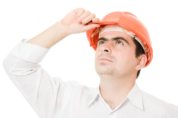 Businessman in a helmet looking up. — Stock Photo, Image