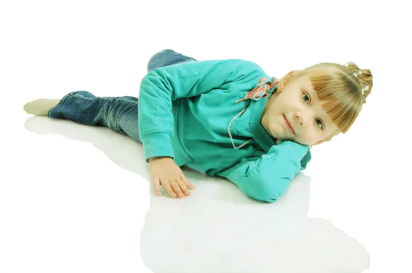 A beautiful little girl lying on the floor. Isolated on the whit — Stock Photo, Image