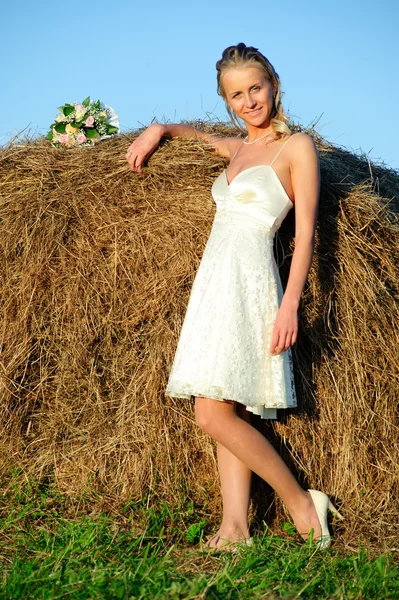Woman near haystack — Stock Photo, Image