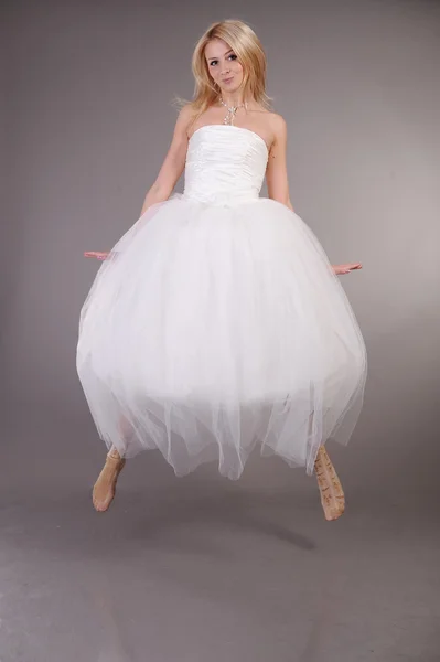 Женщина прыгает в свадебном платье — стоковое фото