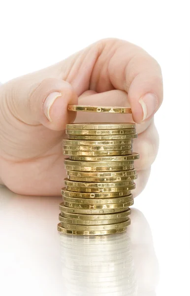 Stack av mynt och mynt i finger med eftertanke — Stockfoto