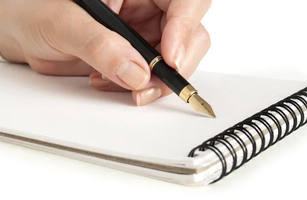 Zakelijke vrouw Schrijven met pen in notitieblok Stockafbeelding