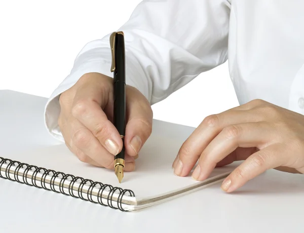 Hand met pen schrijven op de notebook Rechtenvrije Stockfoto's