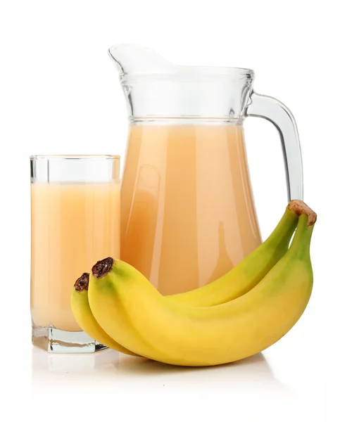 Pełną szklanką i dzbanek na sok banan i owoce na białym tle — Zdjęcie stockowe