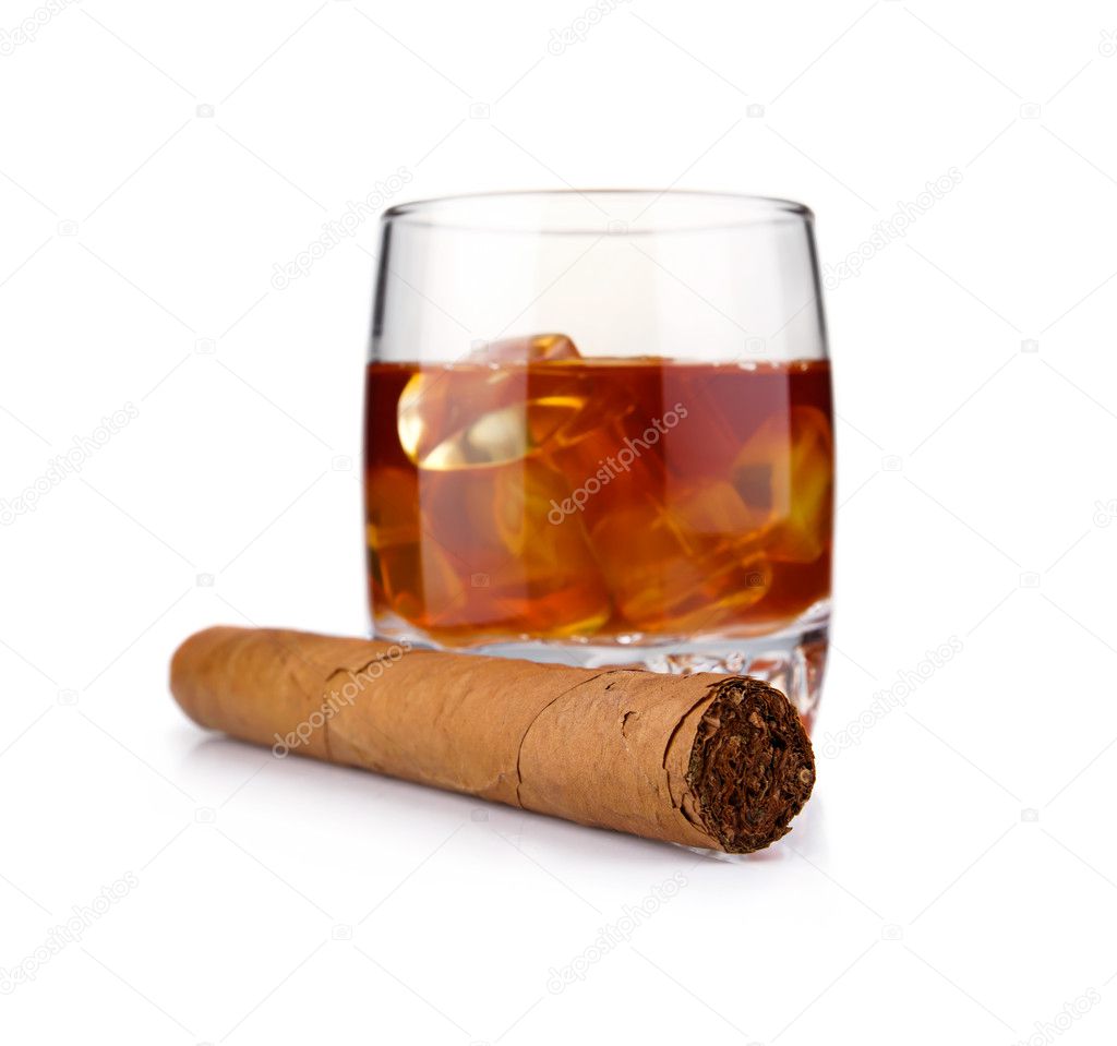 Glass of whiskey with ice cubes and havana cigar isolated