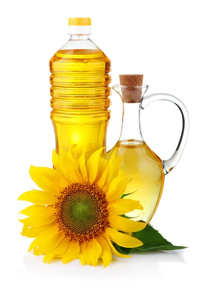 Jarra y botella de aceite de girasol con flor aislada — Foto de Stock