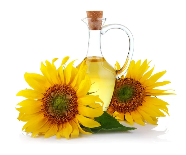 Jug of sunflower oil with flowers isolated — Stock Photo, Image