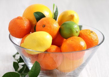 Fresh citrus fruits in the vase clipart