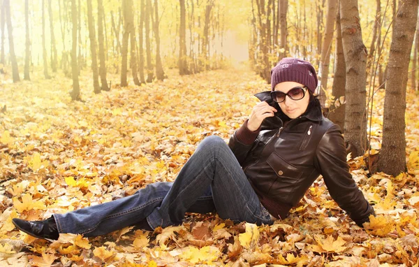 Mladá atraktivní žena v sluneční brýle v parku — Stock fotografie