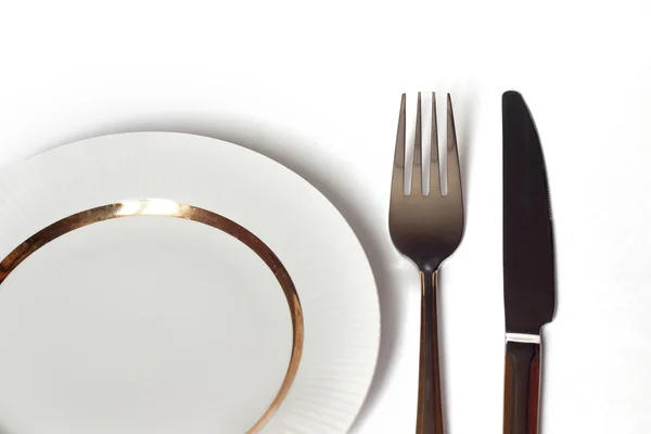 Knife and fork and white plate — Stock Photo, Image