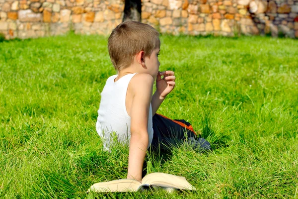 Скучный мальчик с книгой — стоковое фото