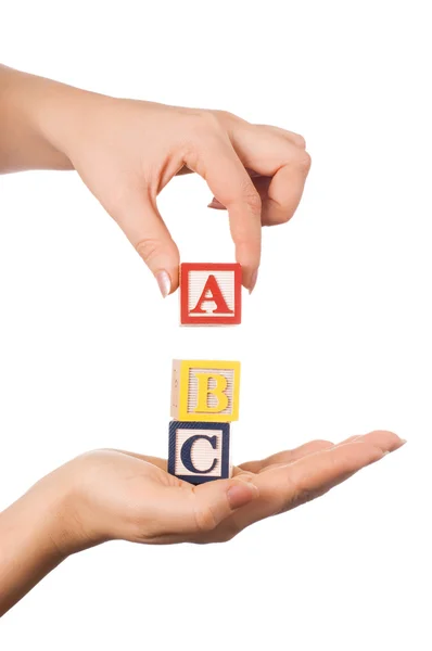 The hand holds a cube with letters — Stock Photo, Image