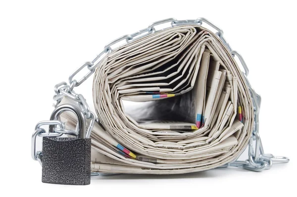 Pile of newspapers with chains — Stock Photo, Image