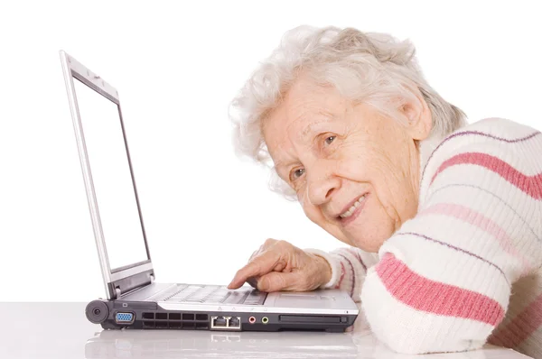 De oudere vrouw achter de computer — Stockfoto