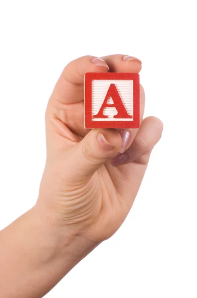 Hand holds a cube with letters — Stock Photo, Image