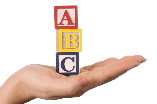 Hand holds a cube with letters — Stock Photo, Image