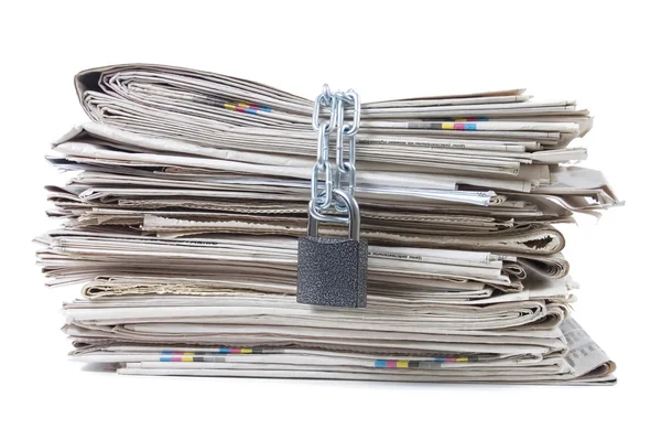 Pile of newspapers with chains — Stock Photo, Image
