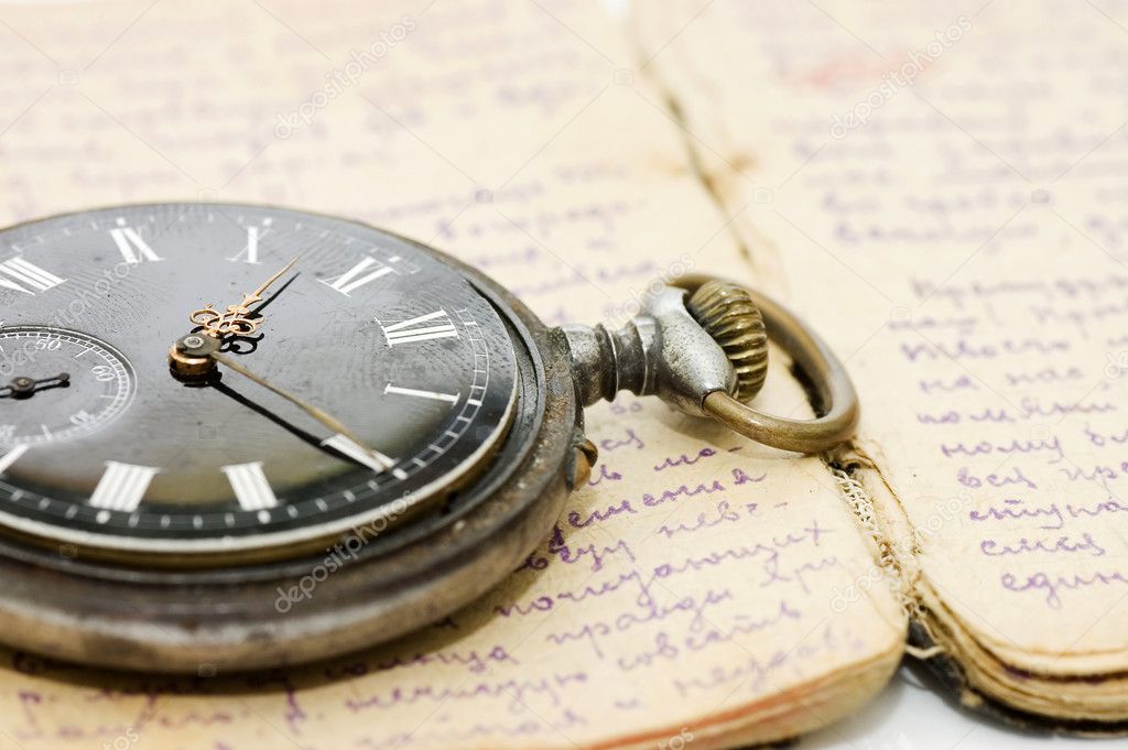 Watch on an old notebook with the text