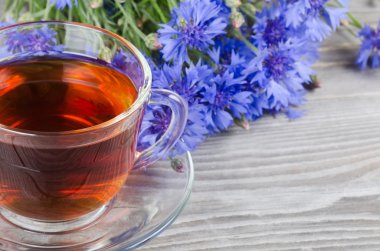 Glass cup with a cornflower tea clipart