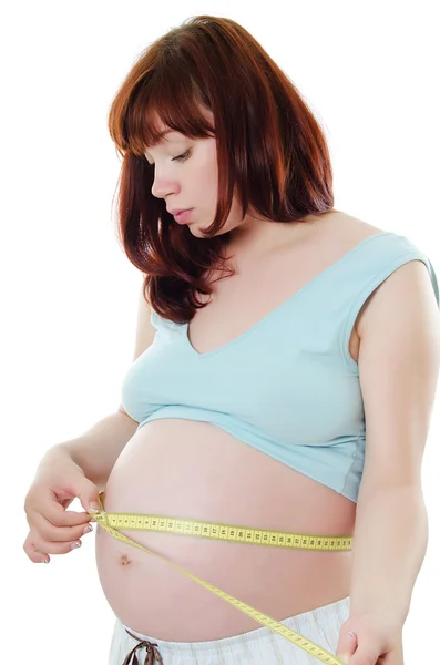 Mujer embarazada con cinta métrica —  Fotos de Stock