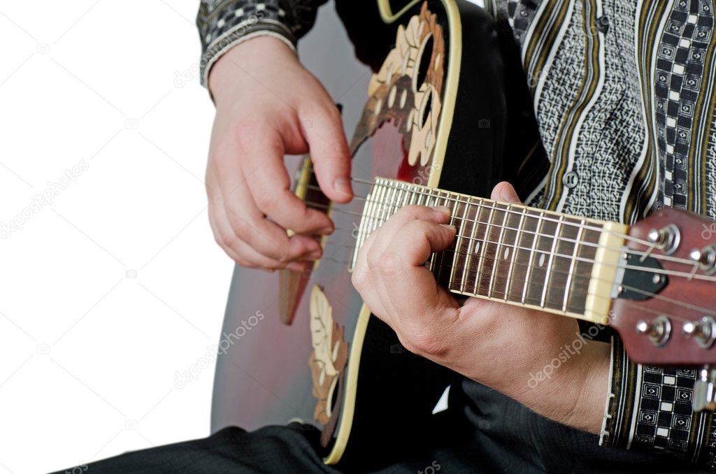The man plays an electric guitar