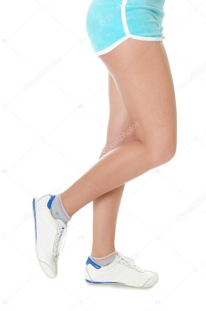 Beautiful female feet in gym shoes