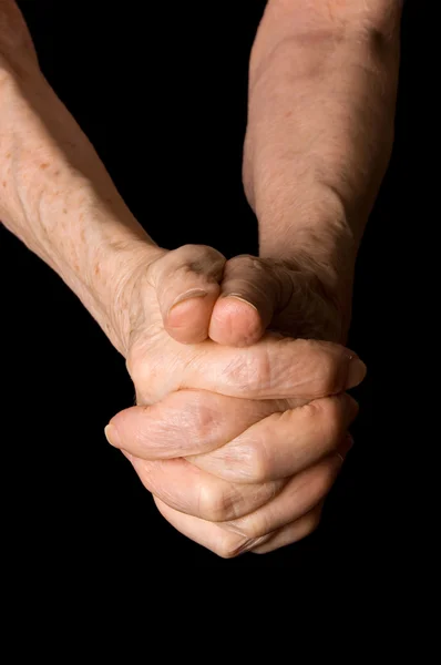 Hands of the old woman on a black background — Stock Photo, Image