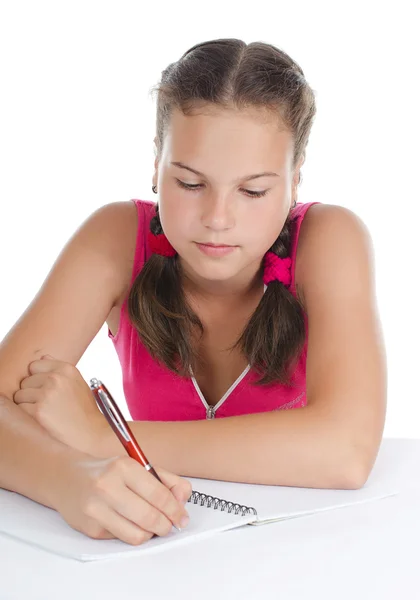 La muchacha joven escribe a los libros de escritura — Foto de Stock