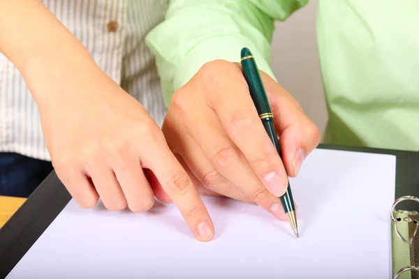 Two businesspeople signing a letter