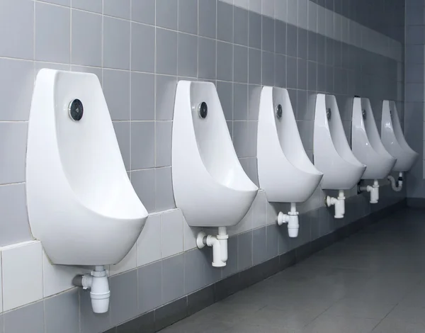 Modern restroom interior with urinal row — Stock Photo, Image