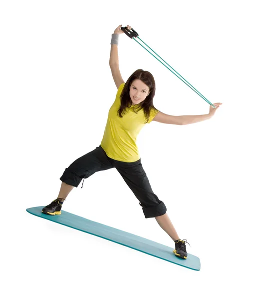Attraktiv ung kvinna med fitness expander i stretching — Stockfoto