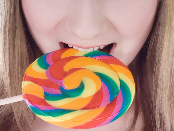 Bright picture of hungry blonde with color lollipop — Stock Photo, Image